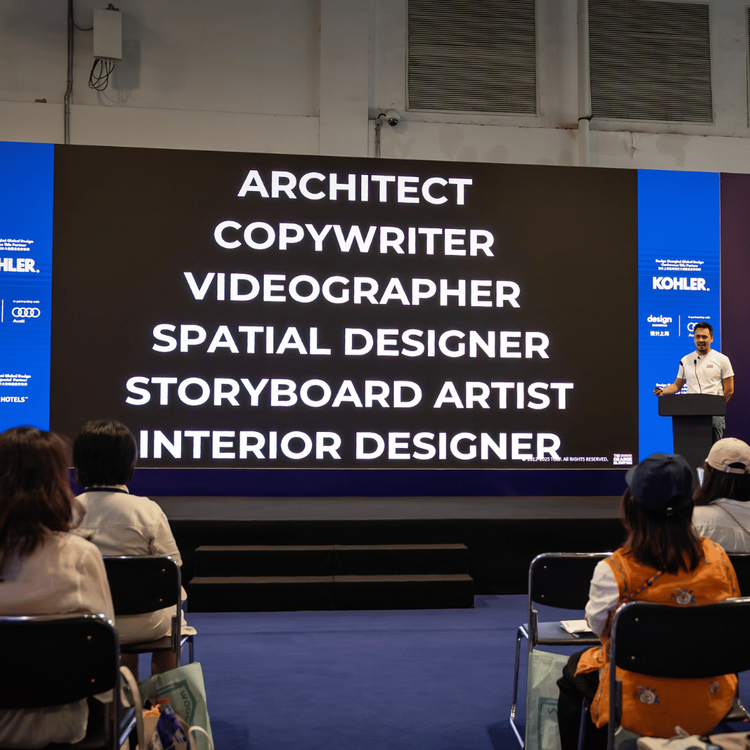 Siu Tang speaking on stage at Design Shanghai 2025 with a slide listing creative job roles behind him
